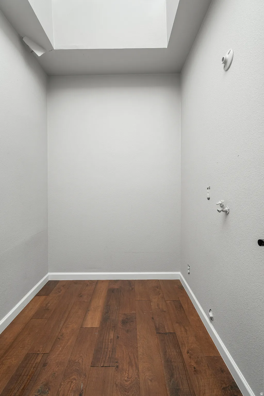 Laundry area featuring dark wood-style flooring and hookup for a gas dryer