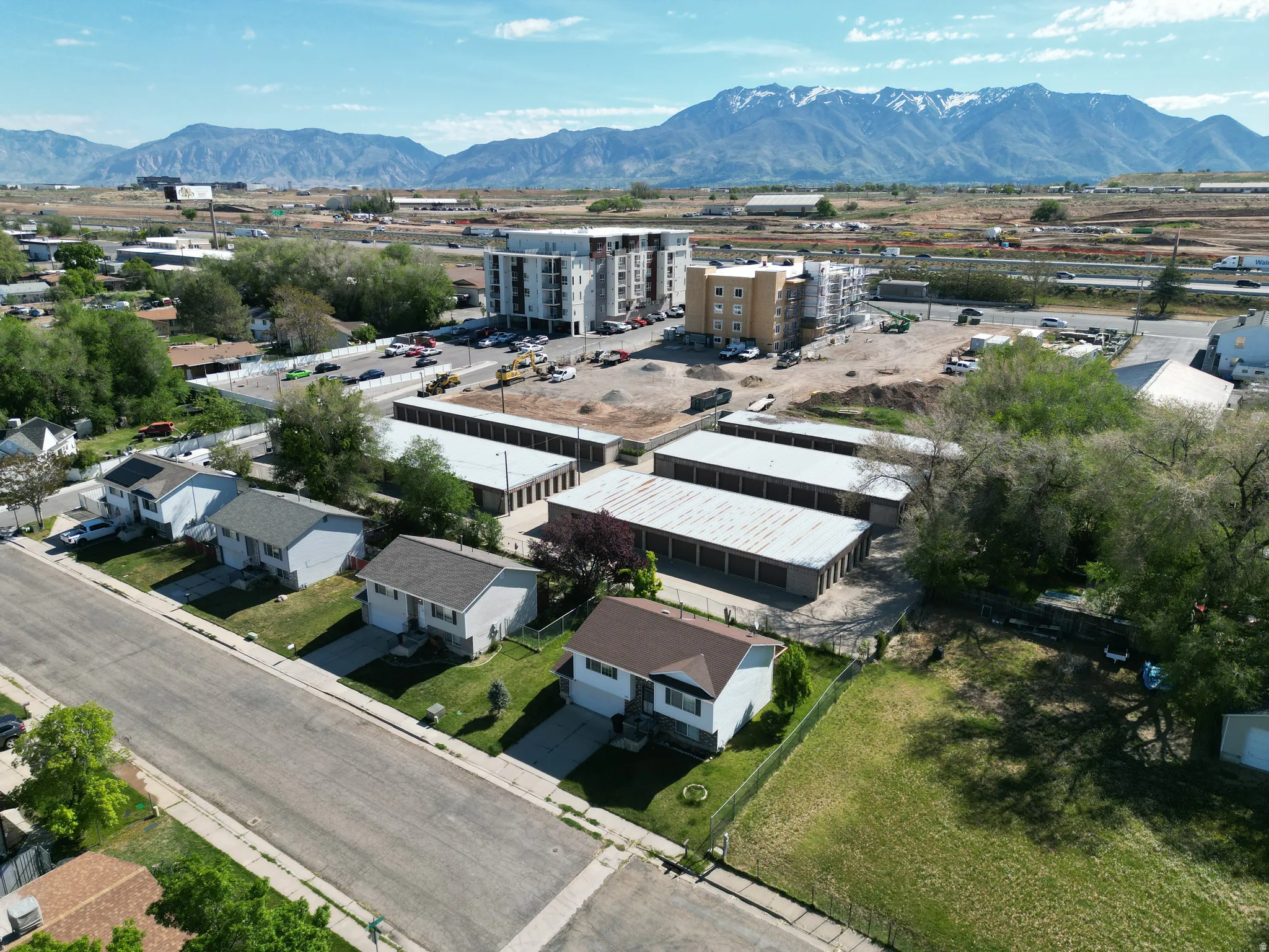 Aerial view of a mountain backdrop and an industrial area