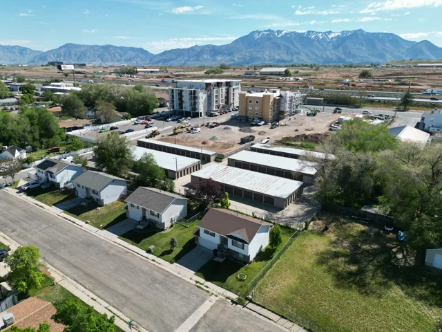 Aerial view of a mountain backdrop and an industrial area
