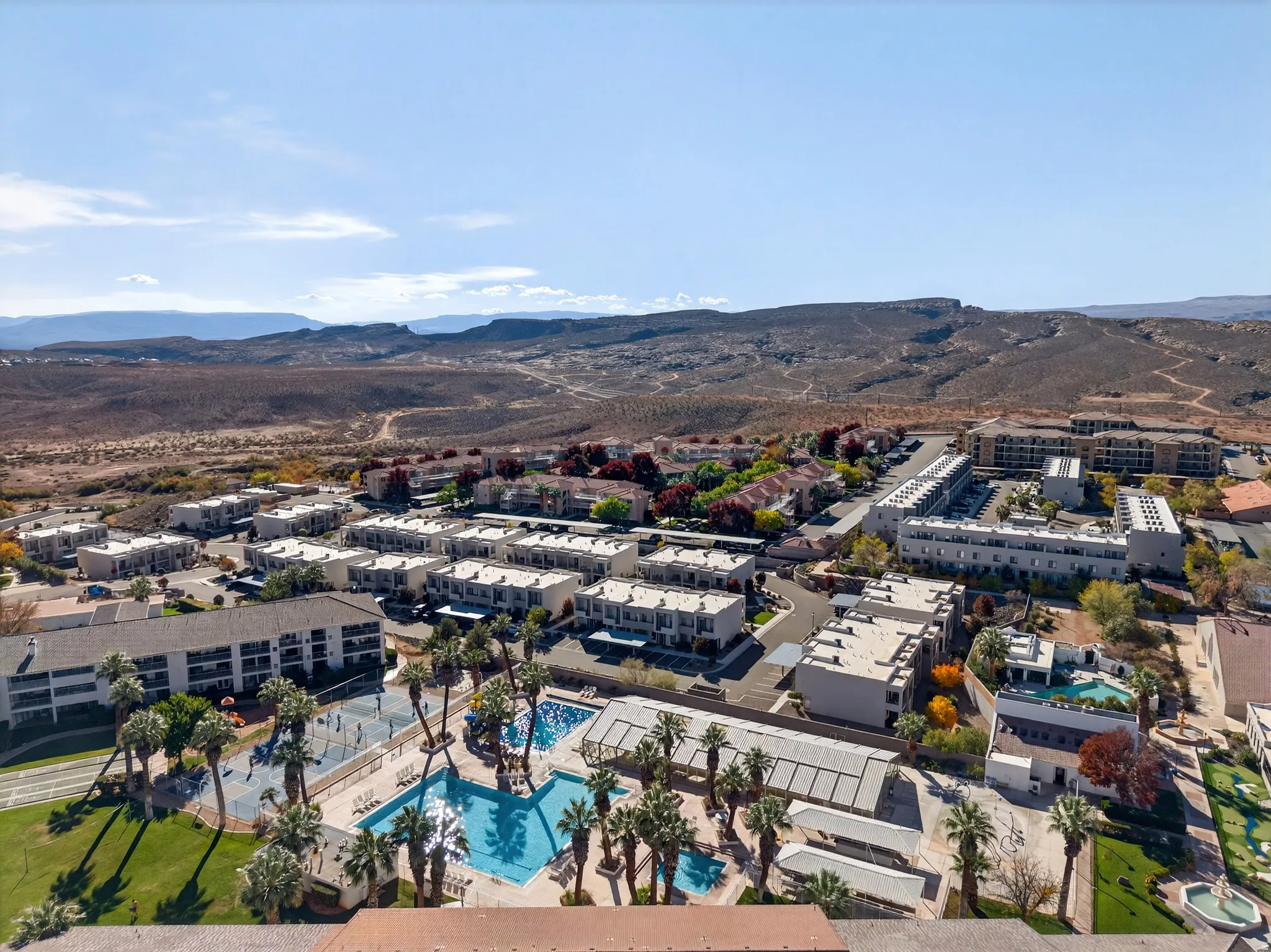 Drone / aerial view of a pool and a mountainous background