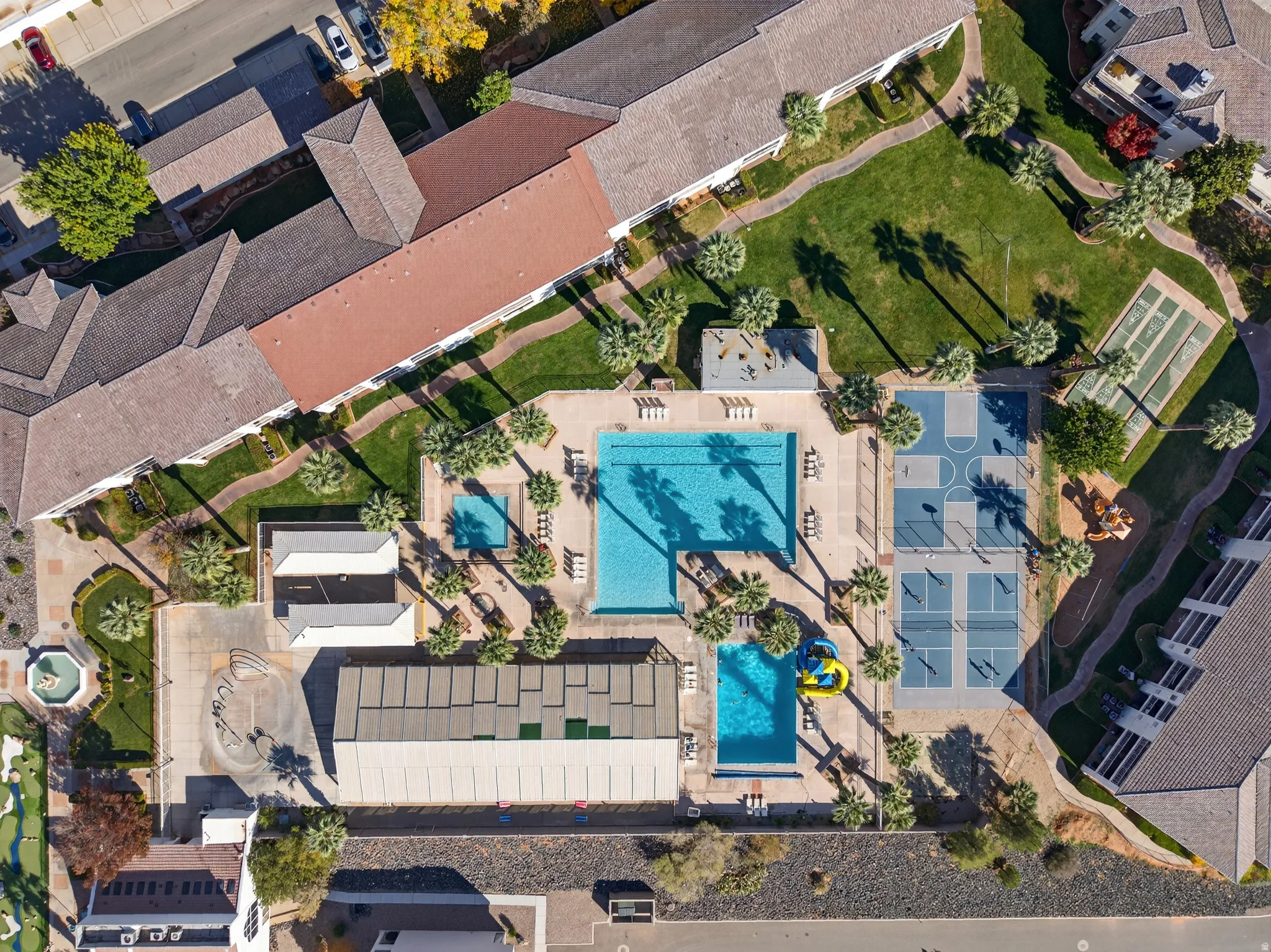 Aerial view of property and surrounding area featuring a pool area