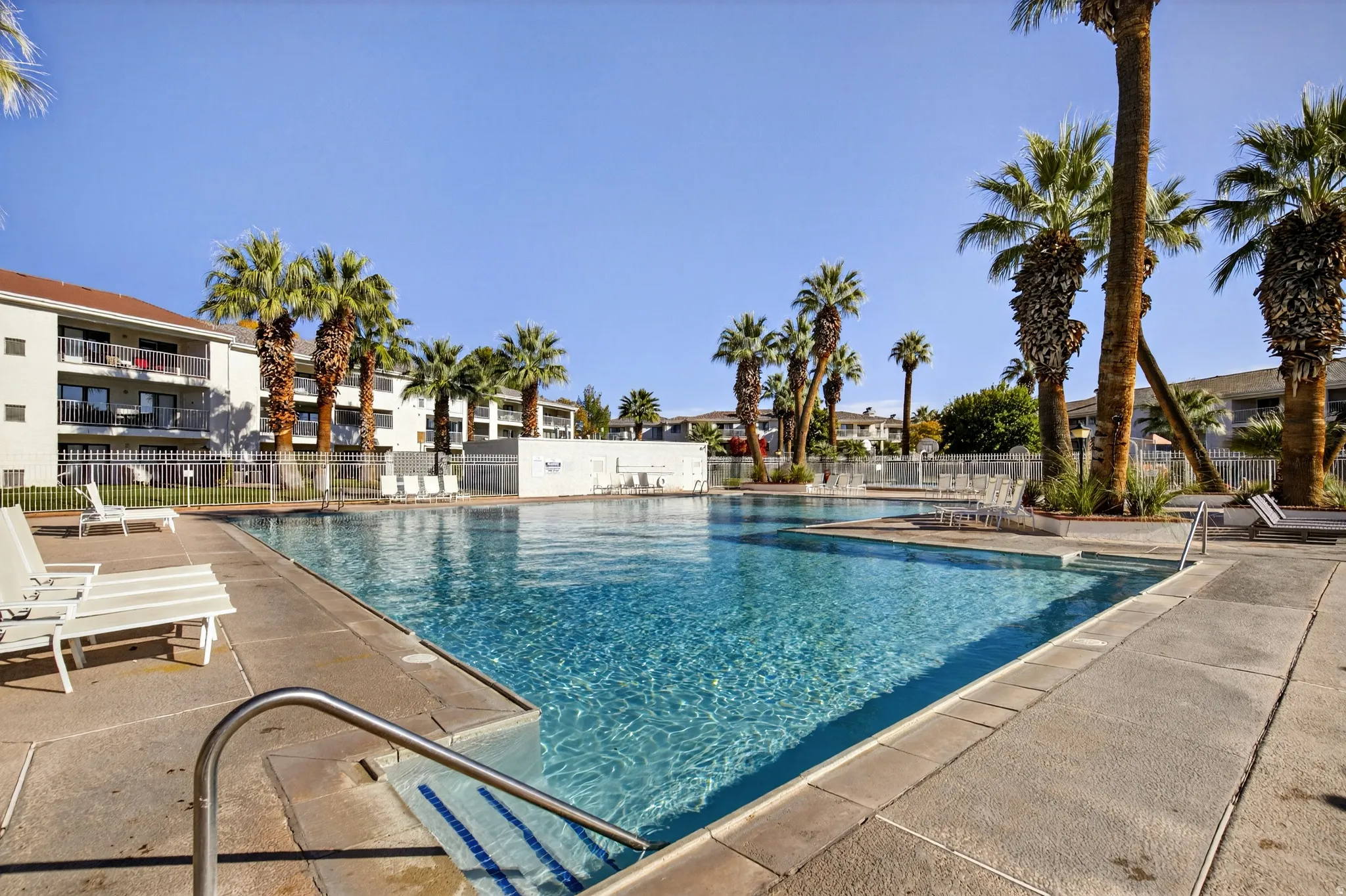 Community pool with a patio