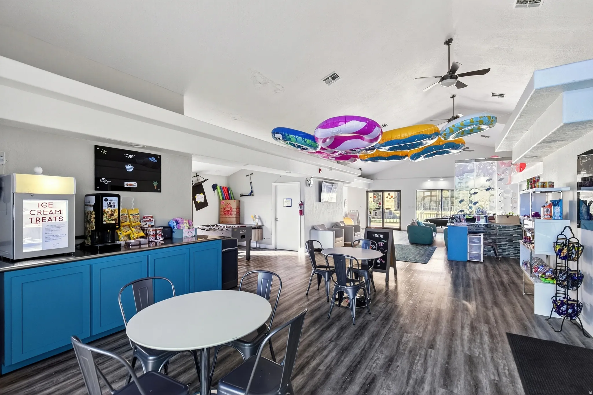Dining room featuring lofted ceiling, dark wood-style floors, and a ceiling fan