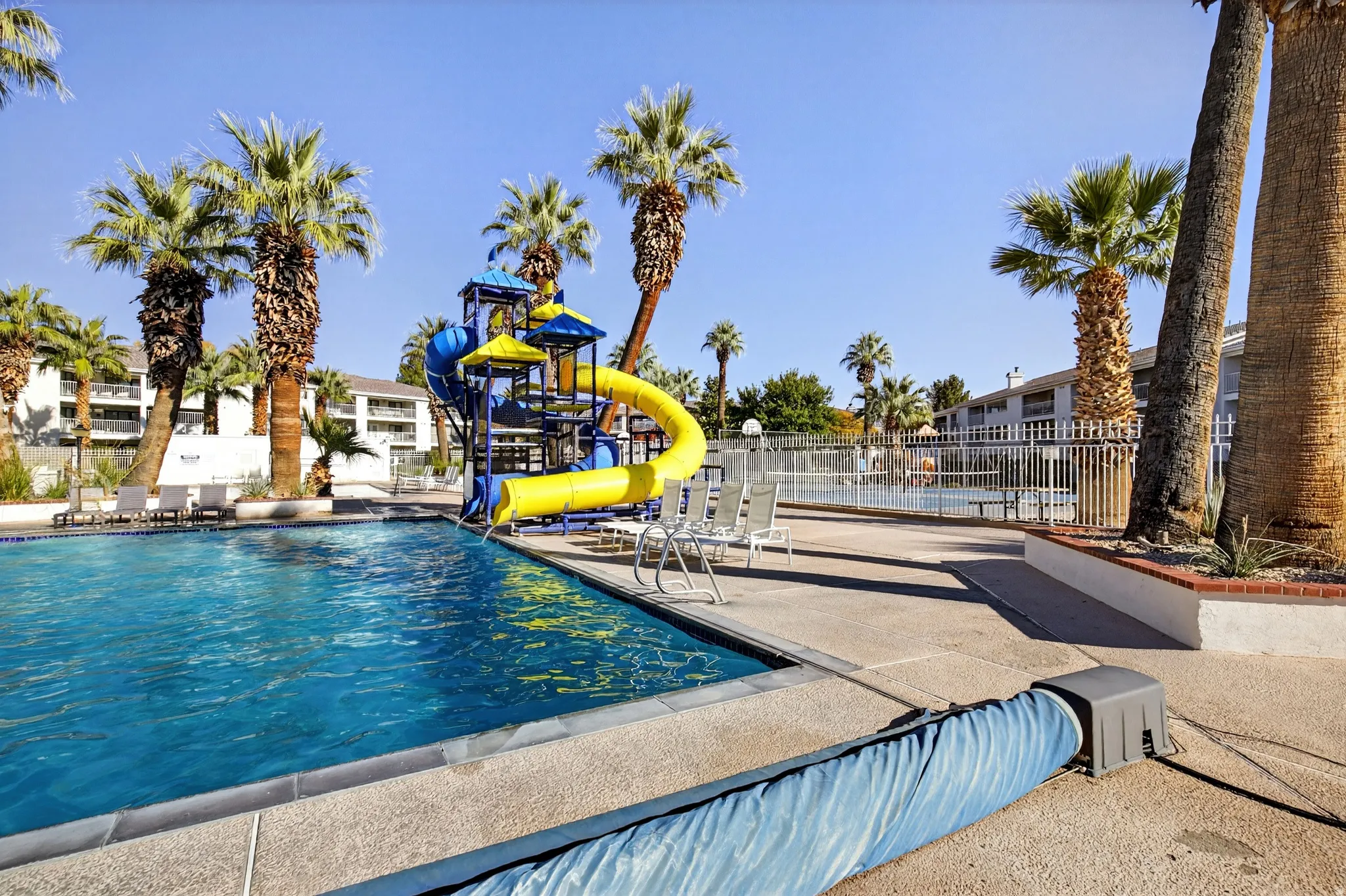 Community pool featuring a water slide