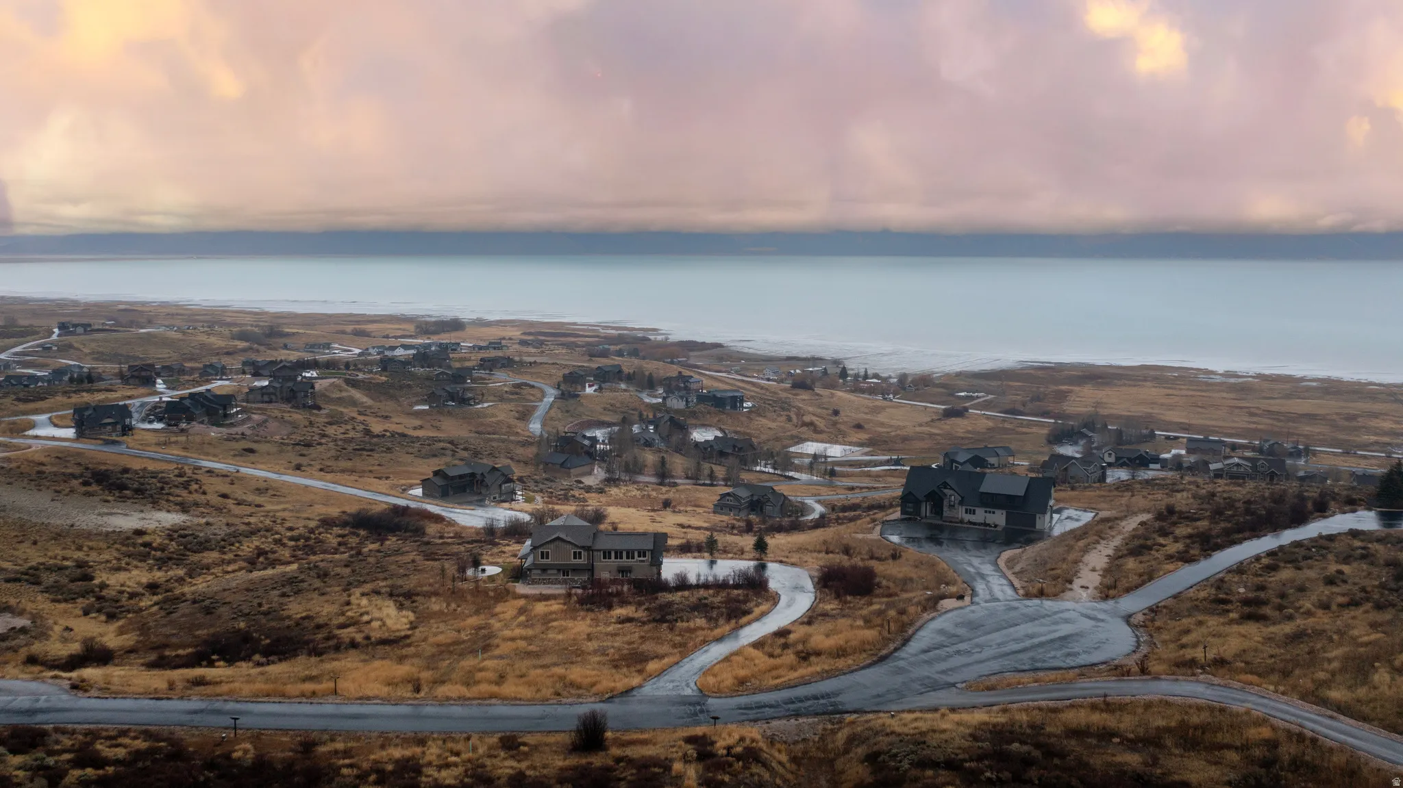 View of property location featuring a large body of water and nearby suburban area