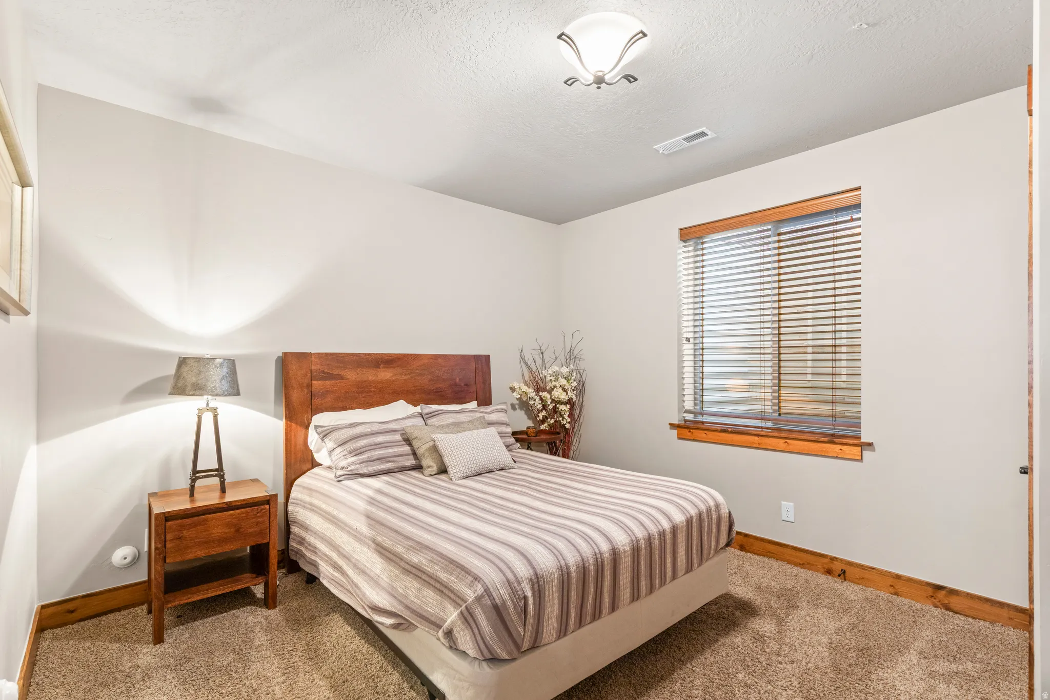 Bedroom with baseboards and carpet flooring