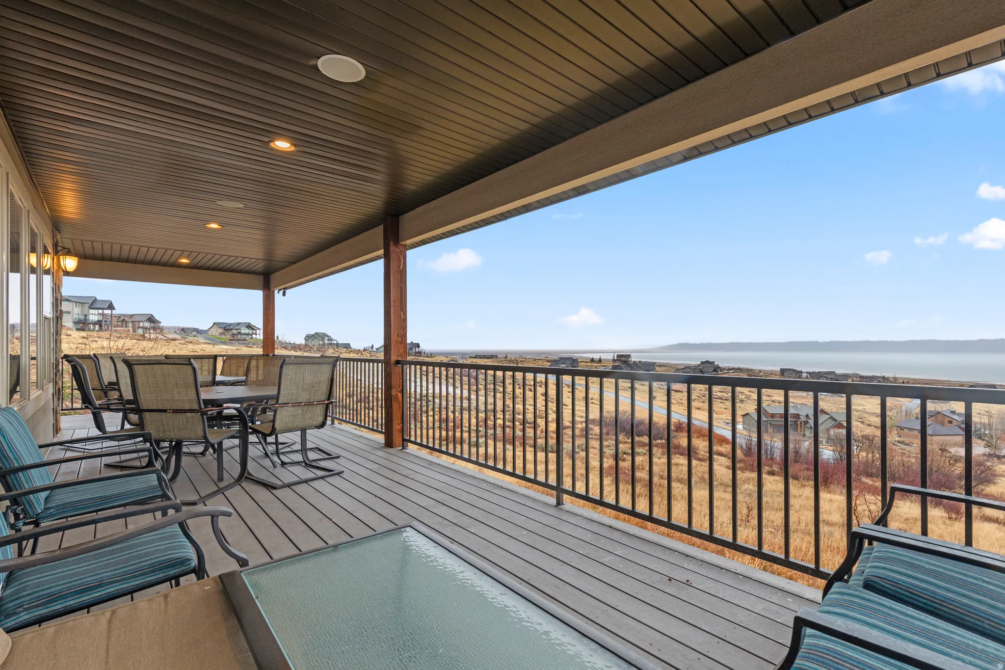 Deck with outdoor dining space and a water view
