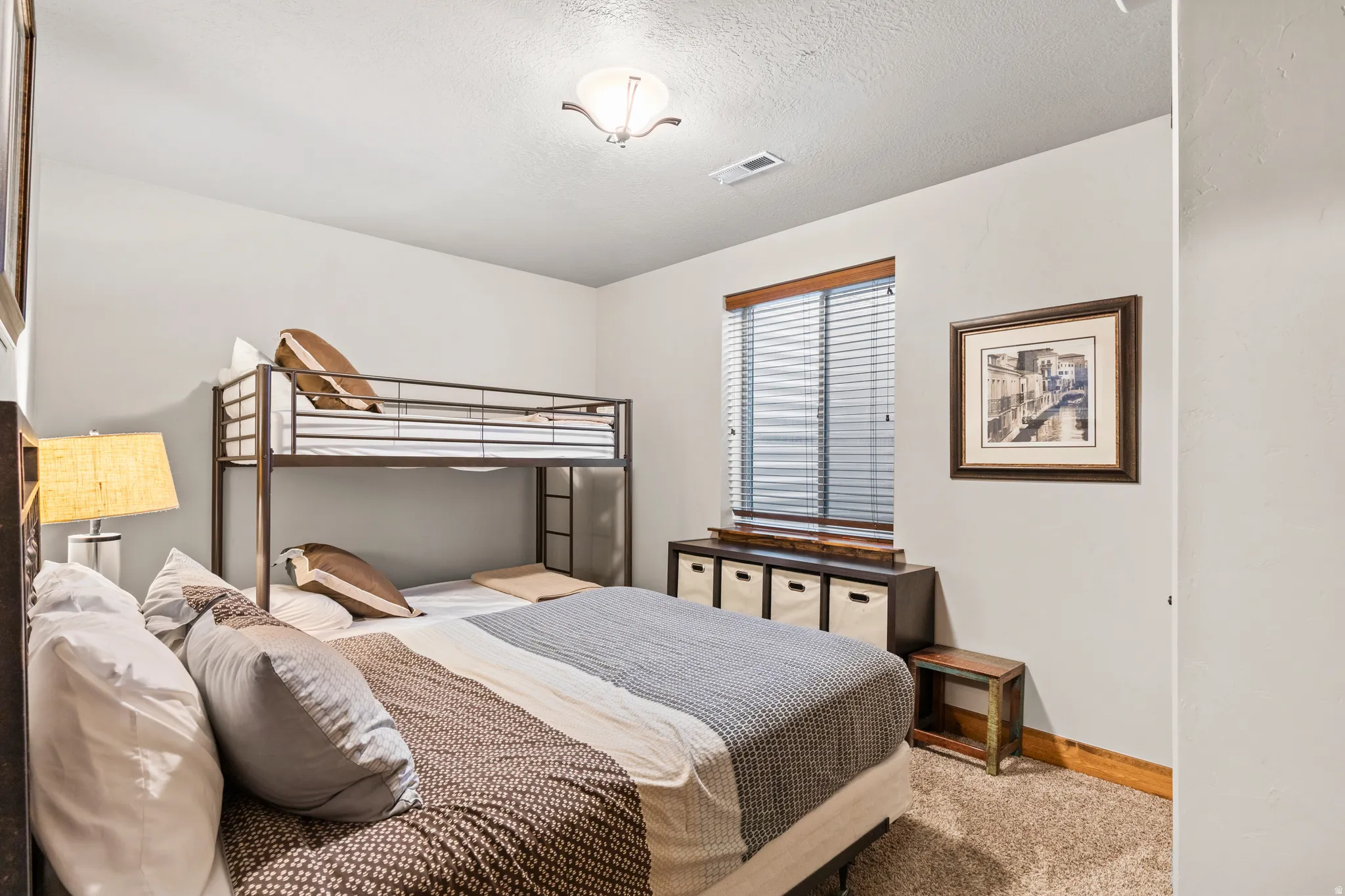 Bedroom featuring carpet floors and a textured ceiling
