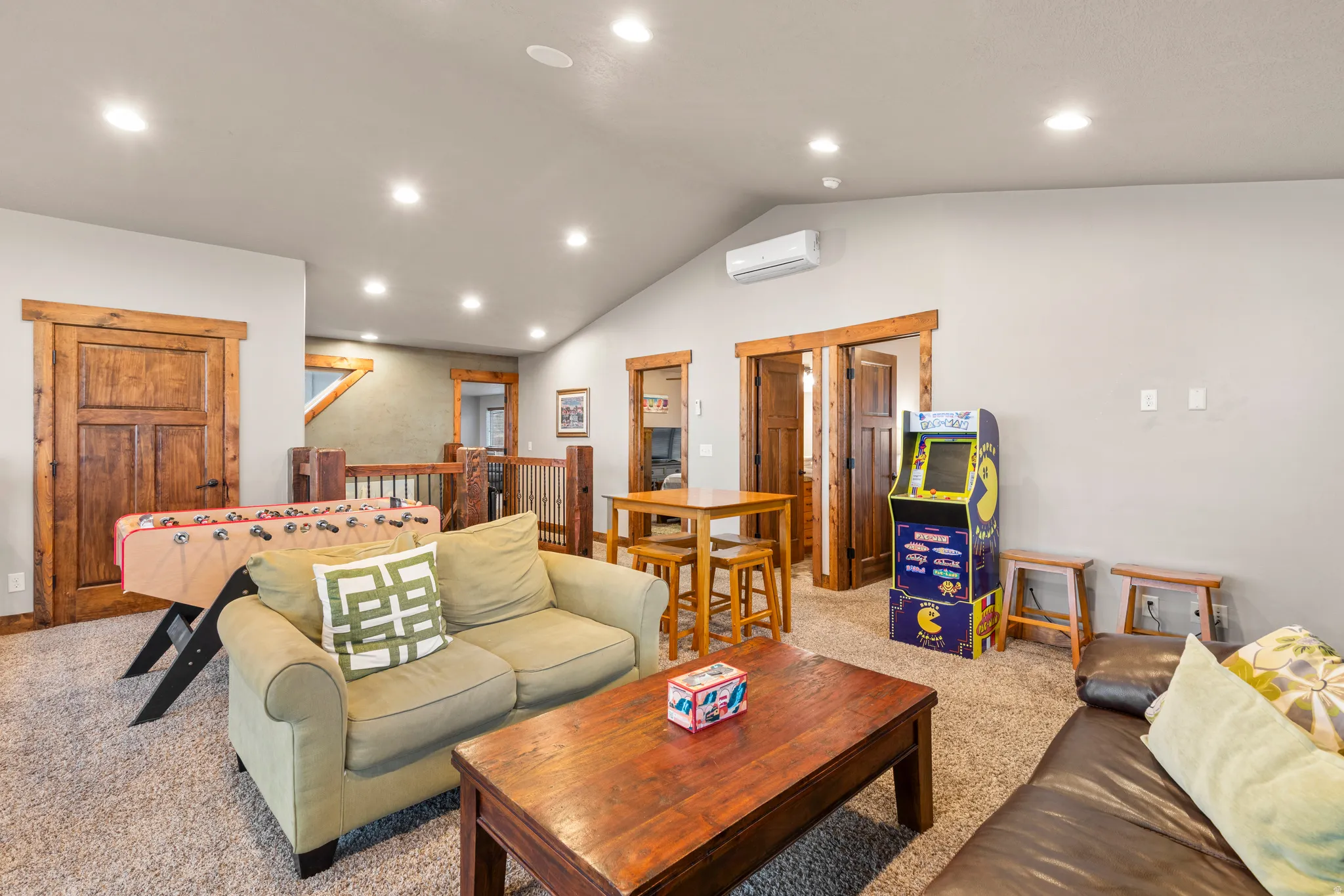 Living room with recessed lighting, vaulted ceiling, and carpet flooring