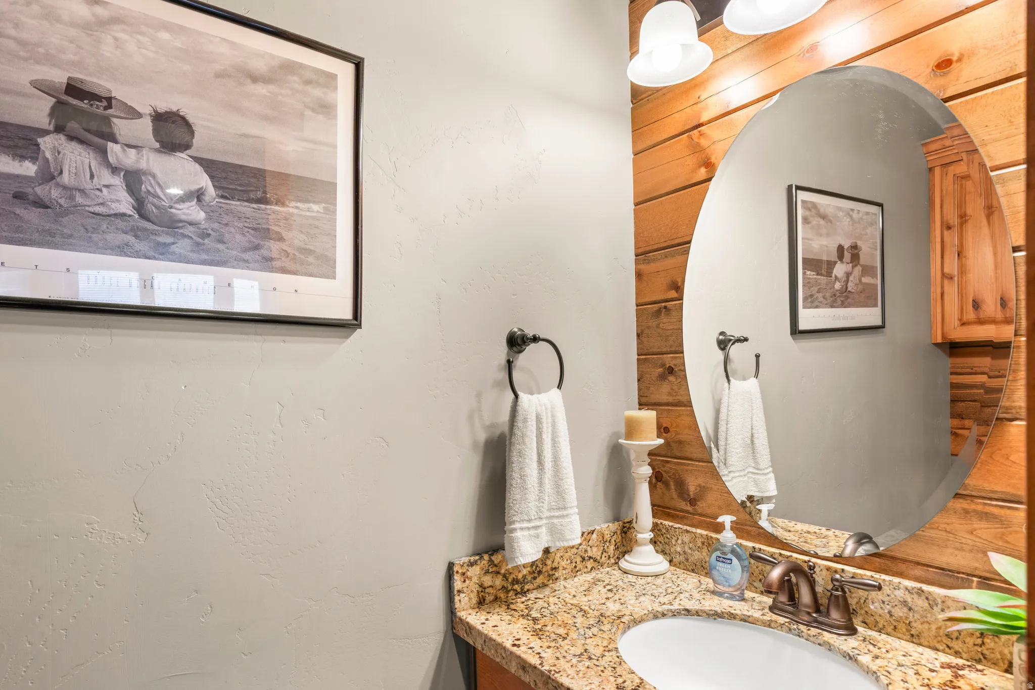 Bathroom with vanity and a textured wall