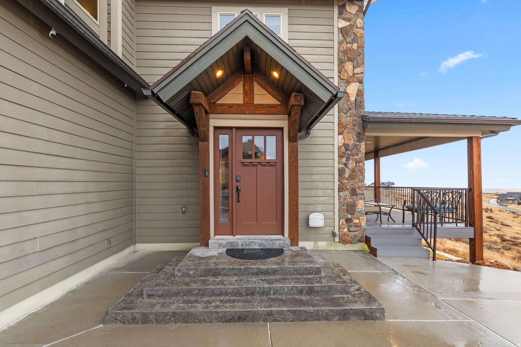 Property entrance featuring stone siding and a porch