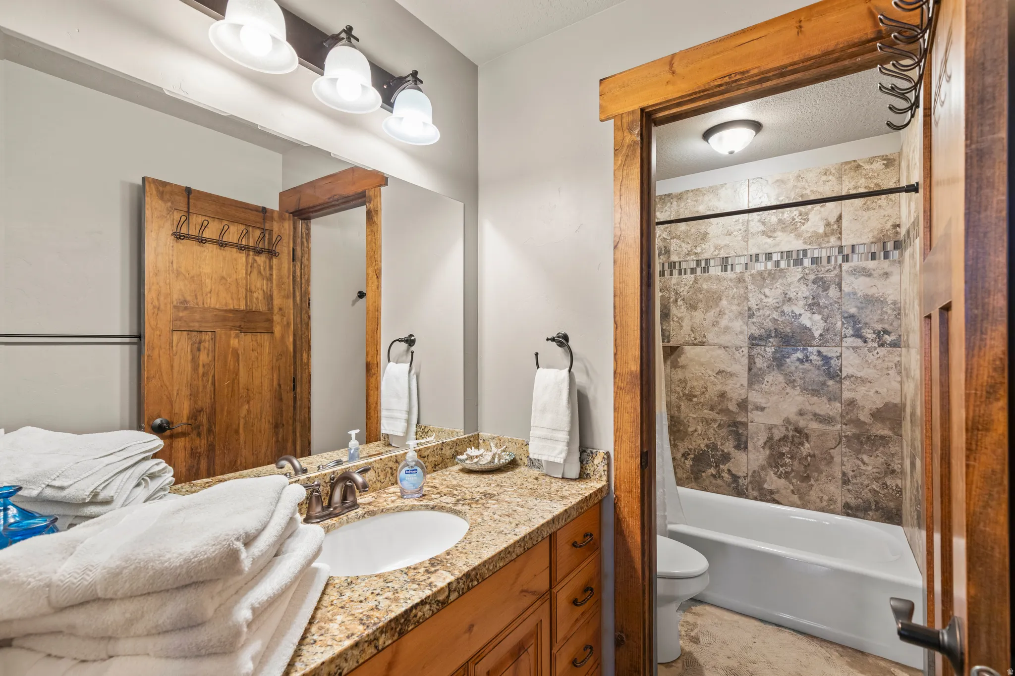 Bathroom featuring vanity and shower / tub combo with curtain