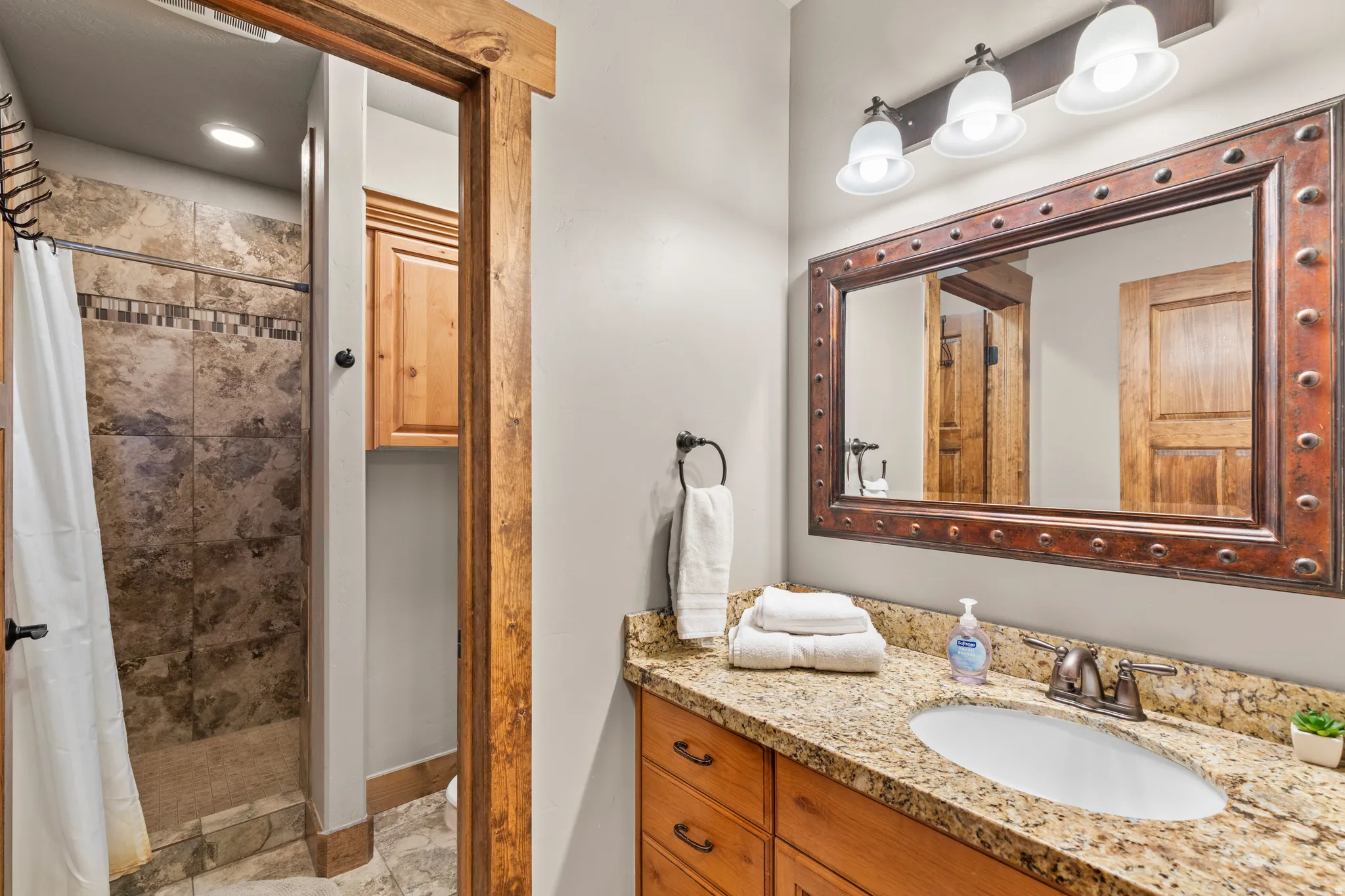 Bathroom featuring a shower stall and vanity