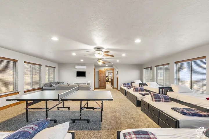 Rec room with recessed lighting, carpet floors, a textured ceiling, and ceiling fan