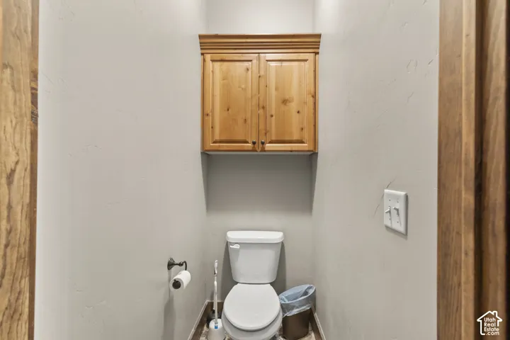 Bathroom featuring toilet and baseboards