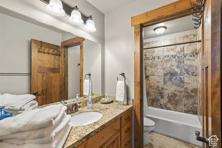 Bathroom featuring vanity and shower / tub combo with curtain