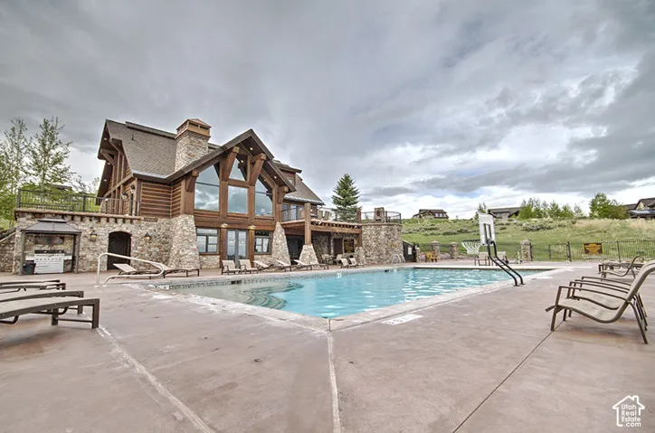 Community pool featuring a patio and a balcony