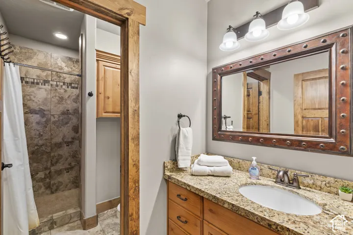 Bathroom featuring a shower stall and vanity