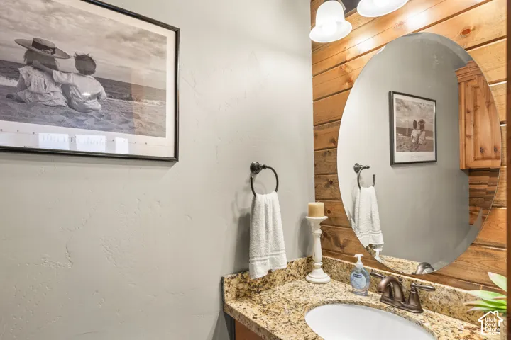 Bathroom with vanity and a textured wall