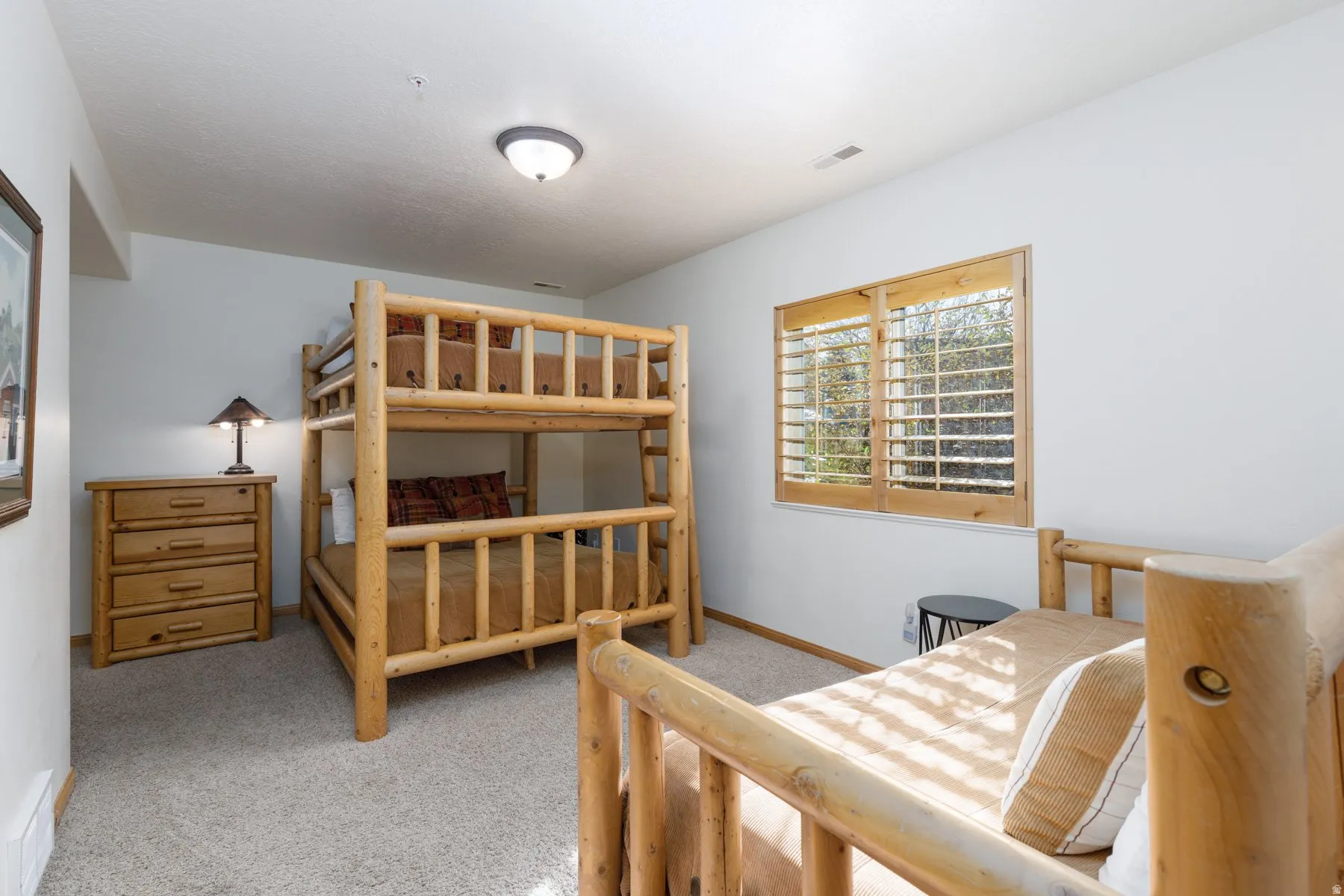 Bedroom featuring light colored carpet and baseboards