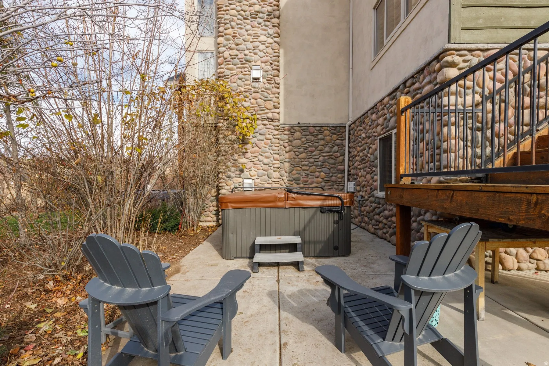 View of patio with a hot tub