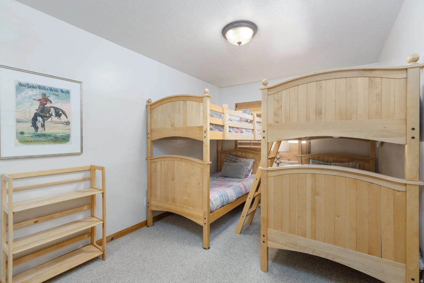 Bedroom with light carpet and baseboards