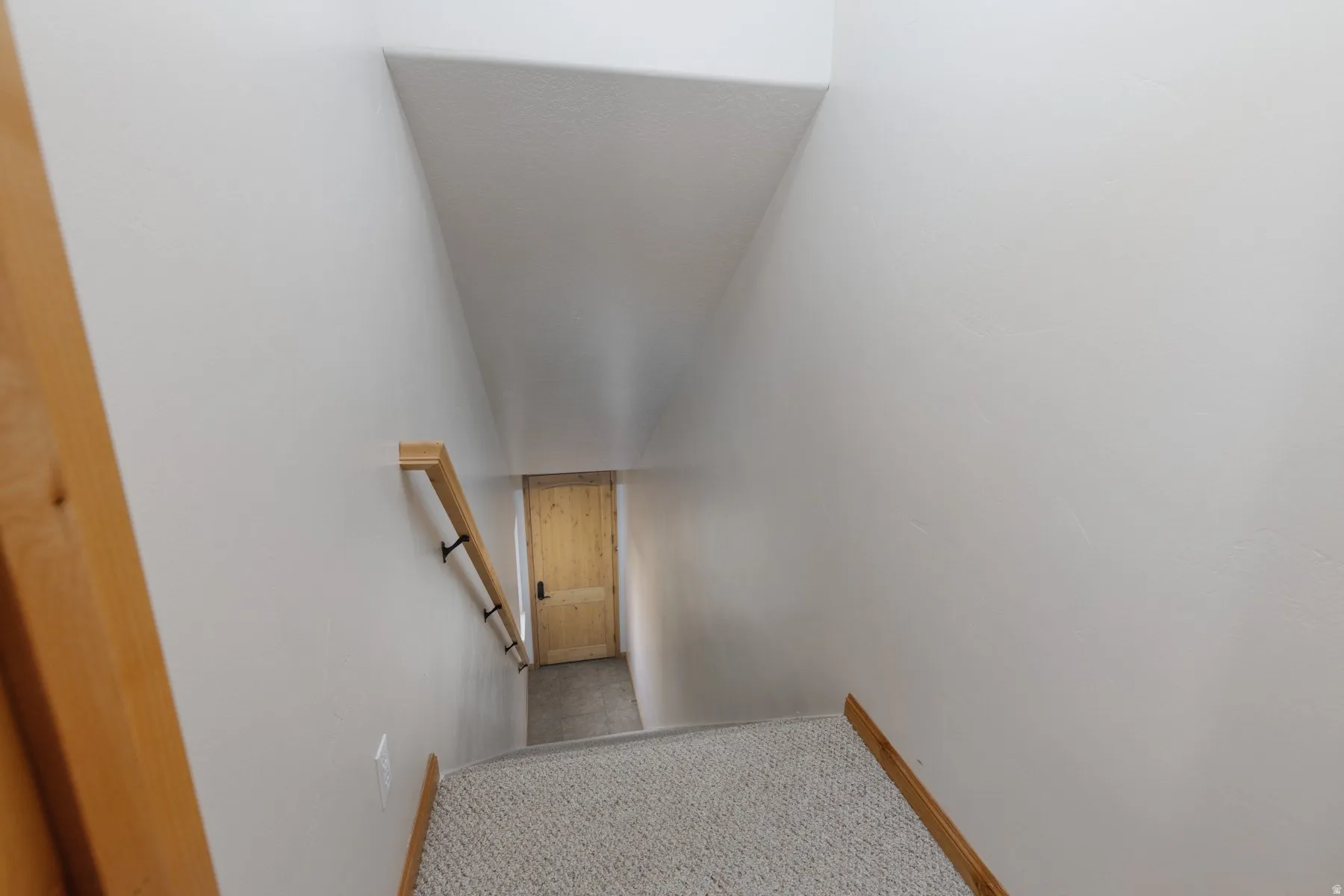 Staircase featuring carpet flooring and baseboards