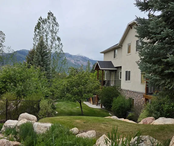 Exterior residence featuring stucco siding and a stone foundation