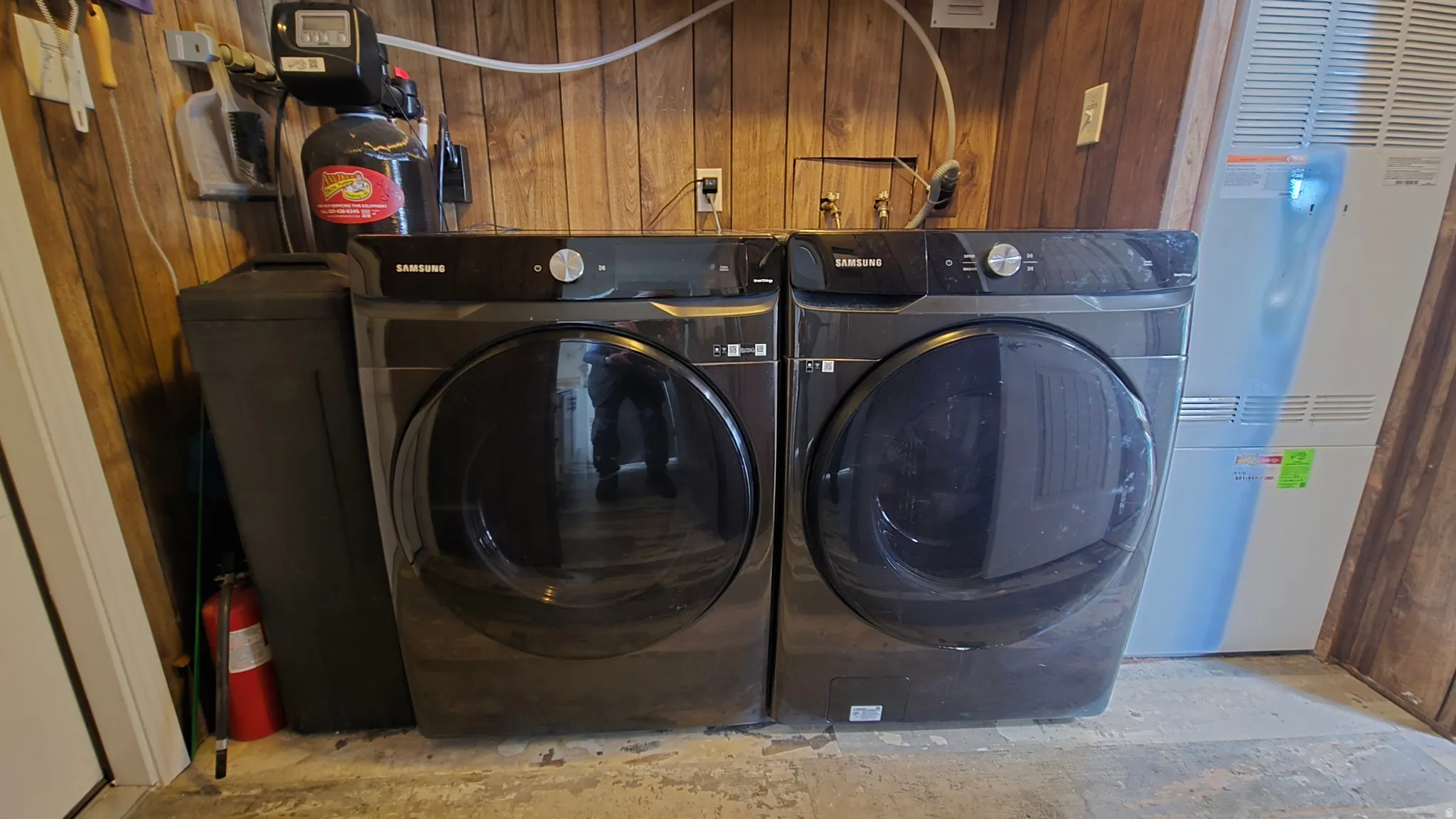 Laundry room featuring a heating unit and separate washer and dryer