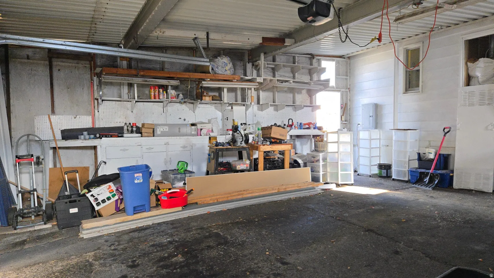 Garage featuring a workshop area and a garage door opener
