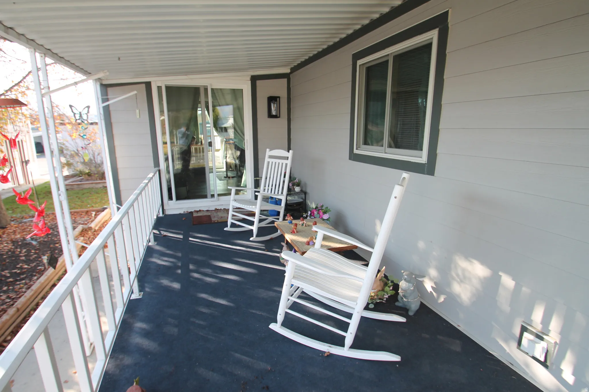 Covered porch featuring a sunroom