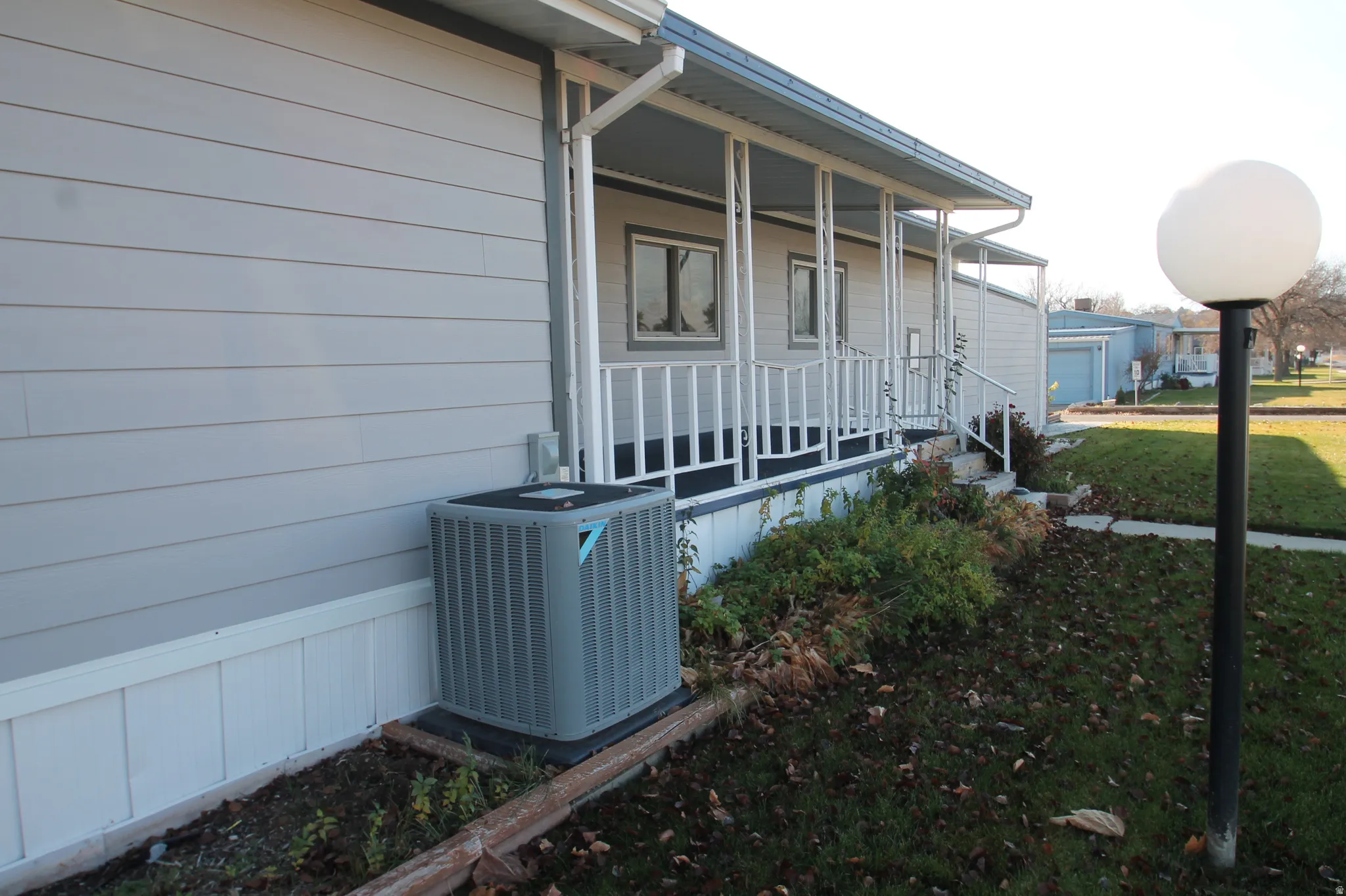 View of home's exterior featuring a porch and a cooling unit
