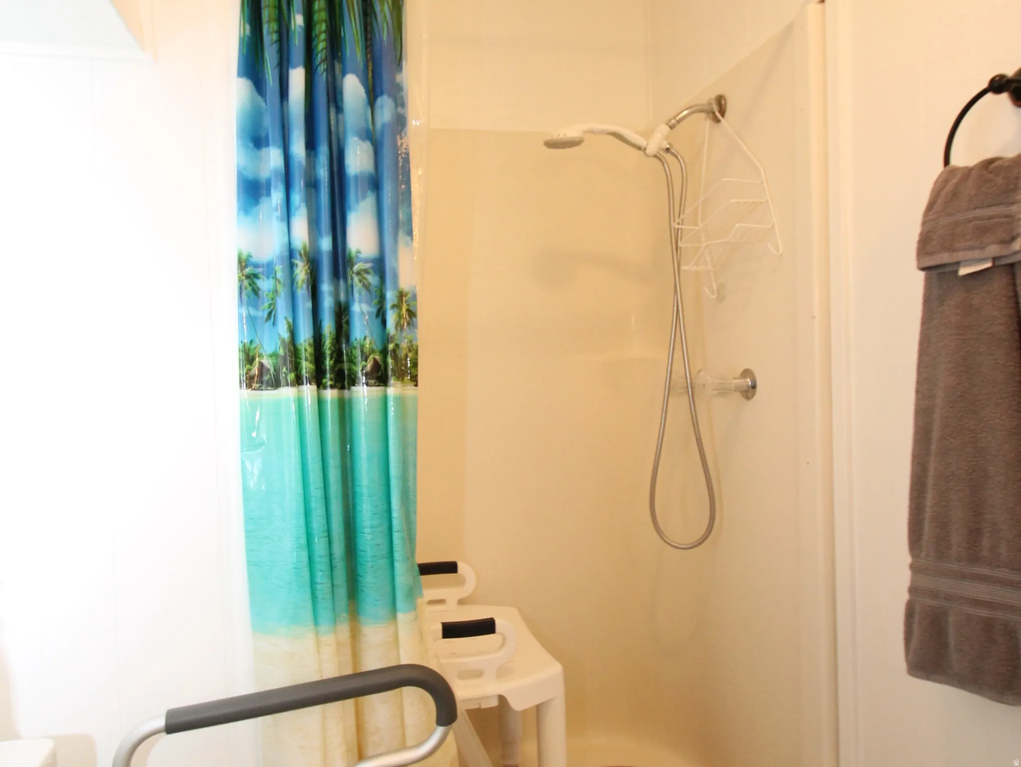 Bathroom with a shower stall and toilet