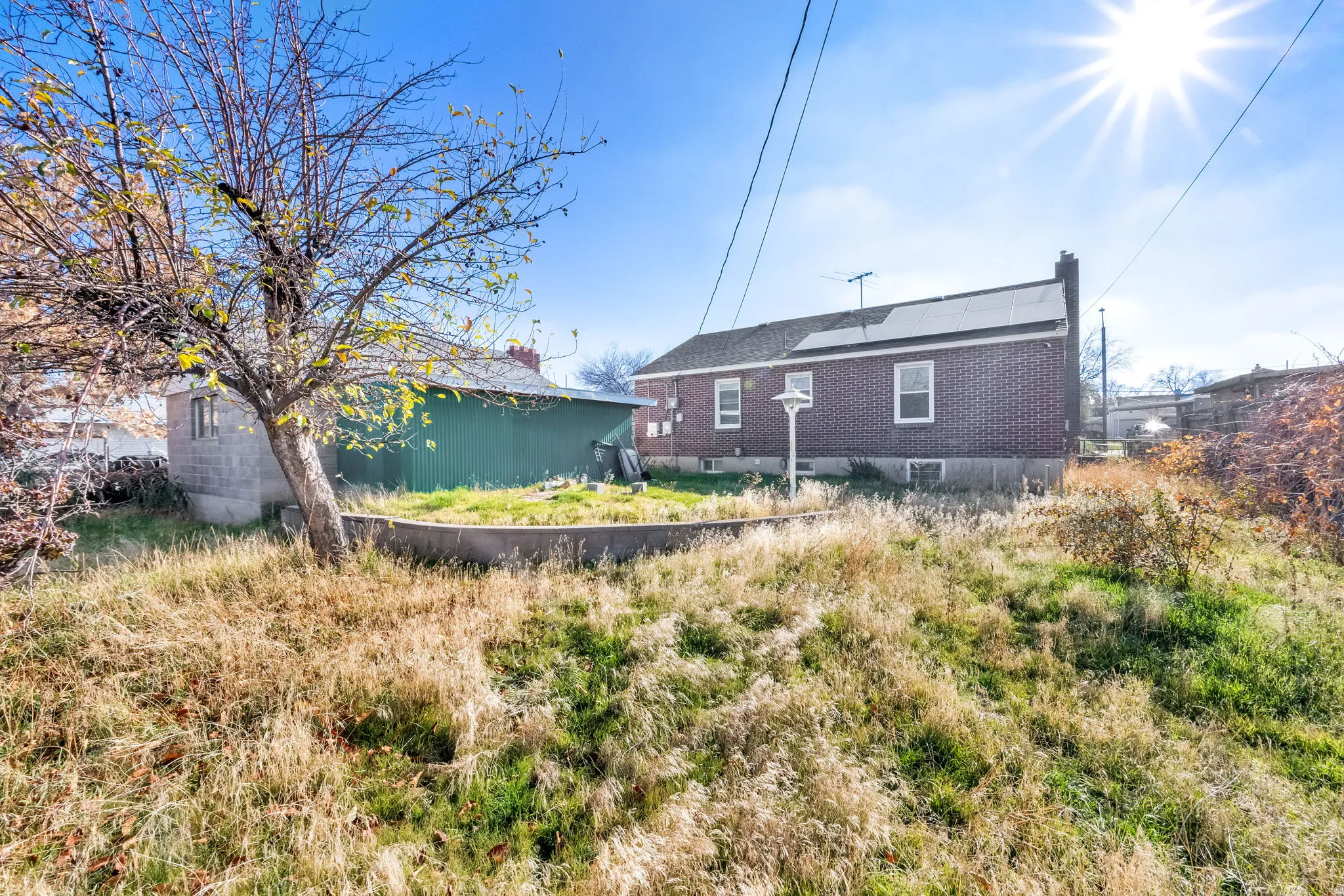 Rear view of property featuring roof mounted solar panels and a chimney