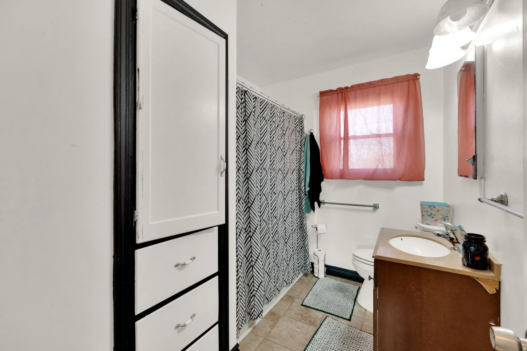 Full bathroom featuring vanity, a shower with curtain, and light tile patterned floors