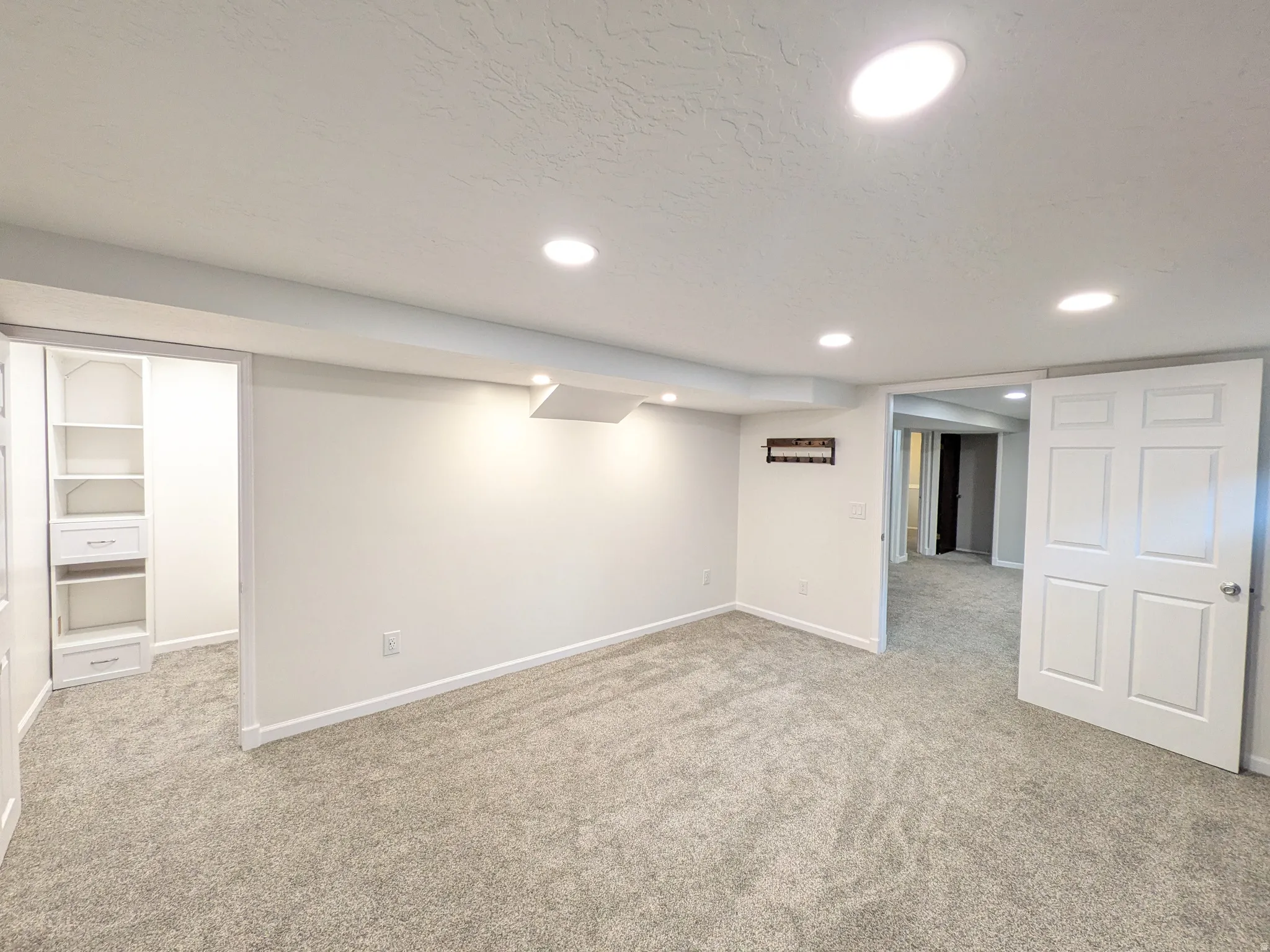 Finished basement featuring light colored carpet and recessed lighting