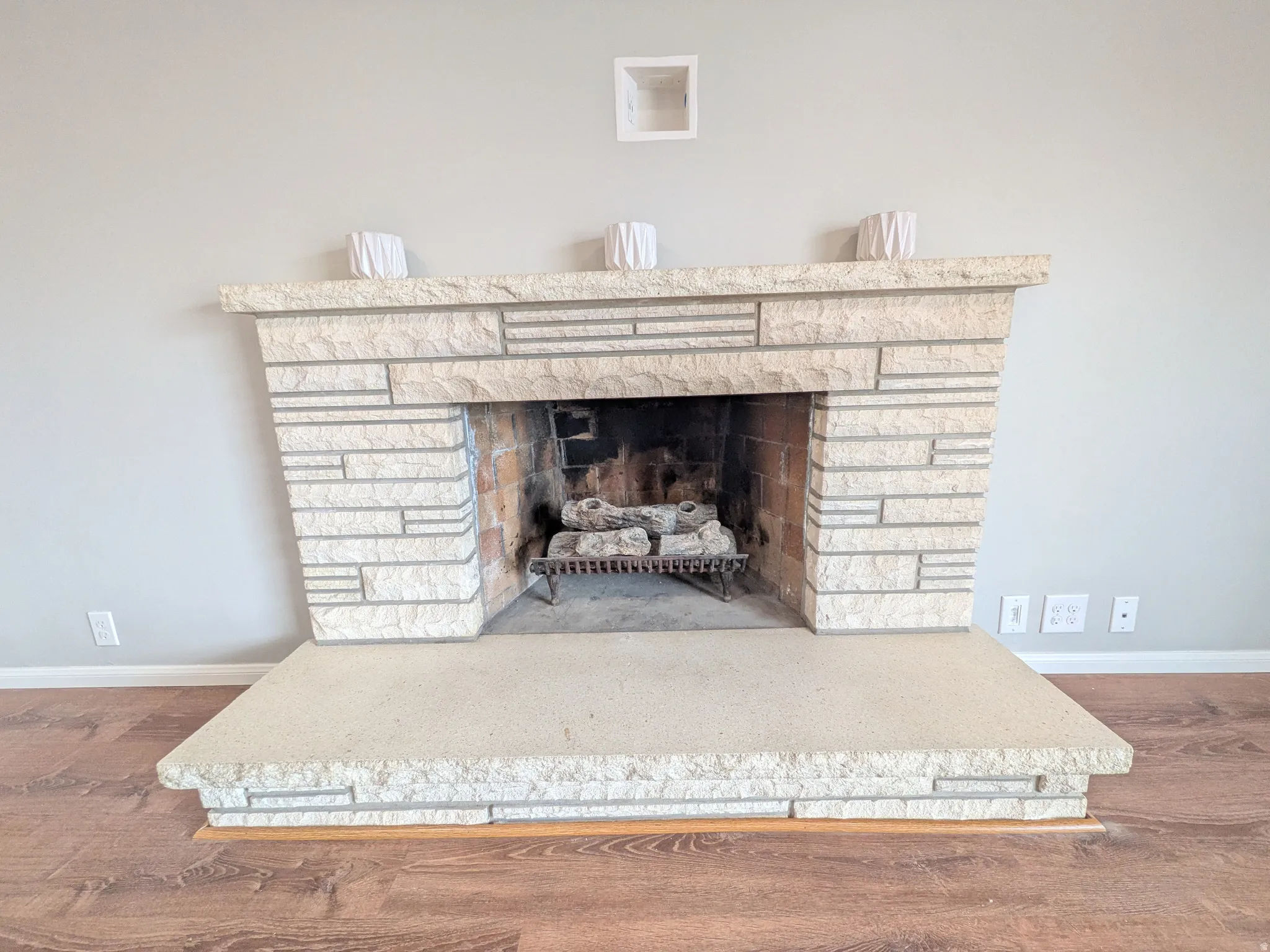 Detailed view of wood finished floors and a fireplace