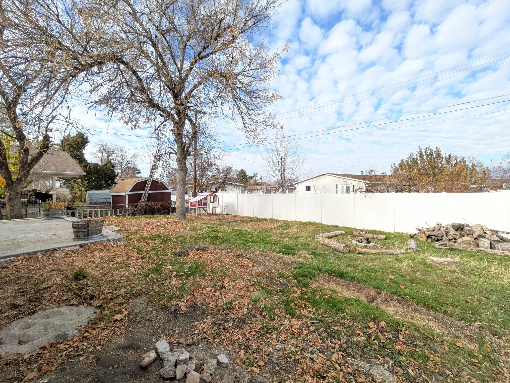 Fenced backyard with an outbuilding