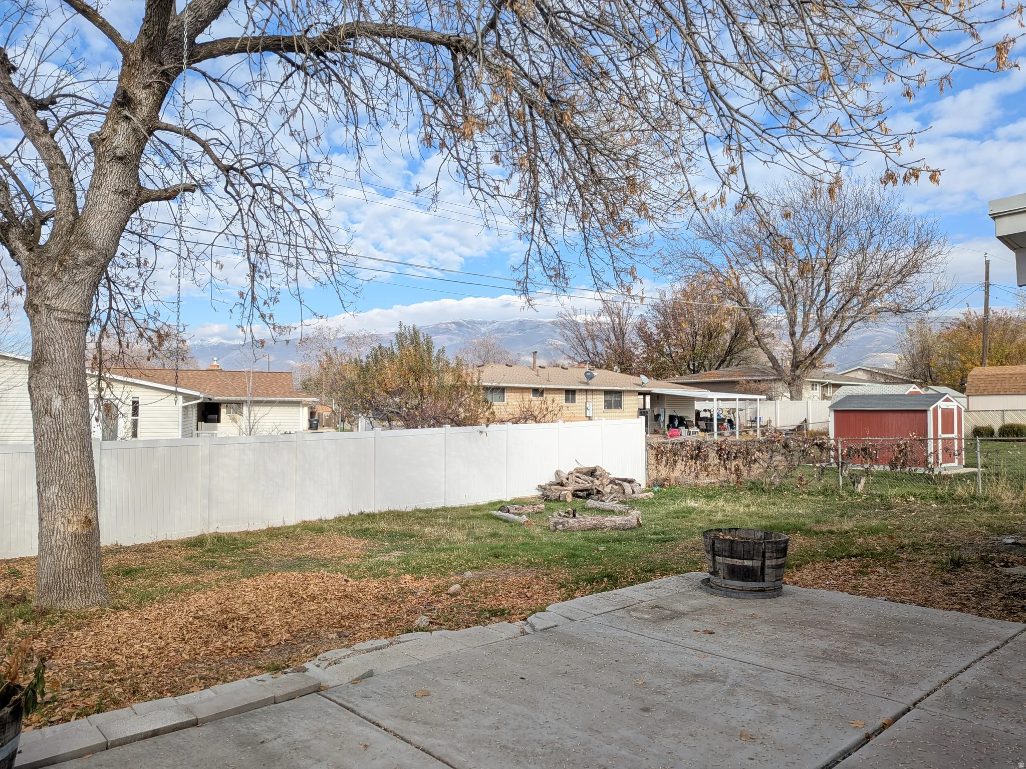 Fenced backyard with a patio and a shed