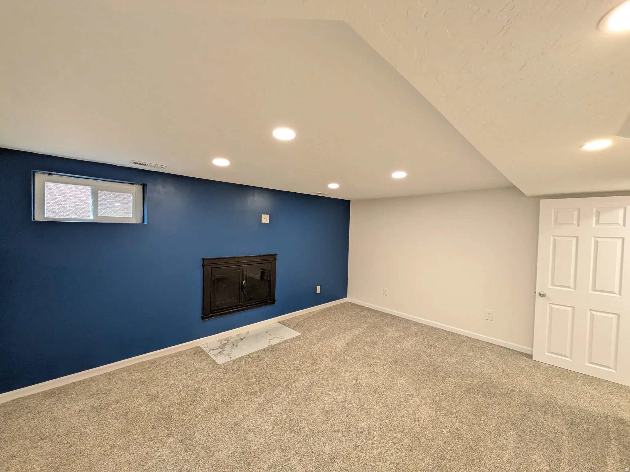 Below grade area featuring recessed lighting and carpet flooring