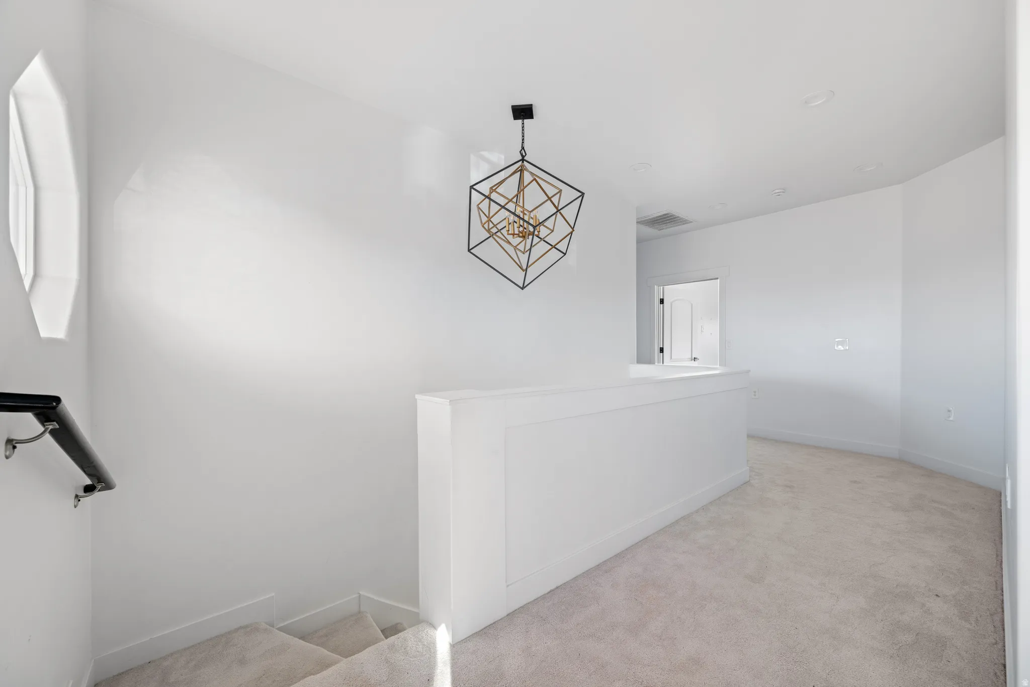 Stairs featuring carpet floors and a chandelier