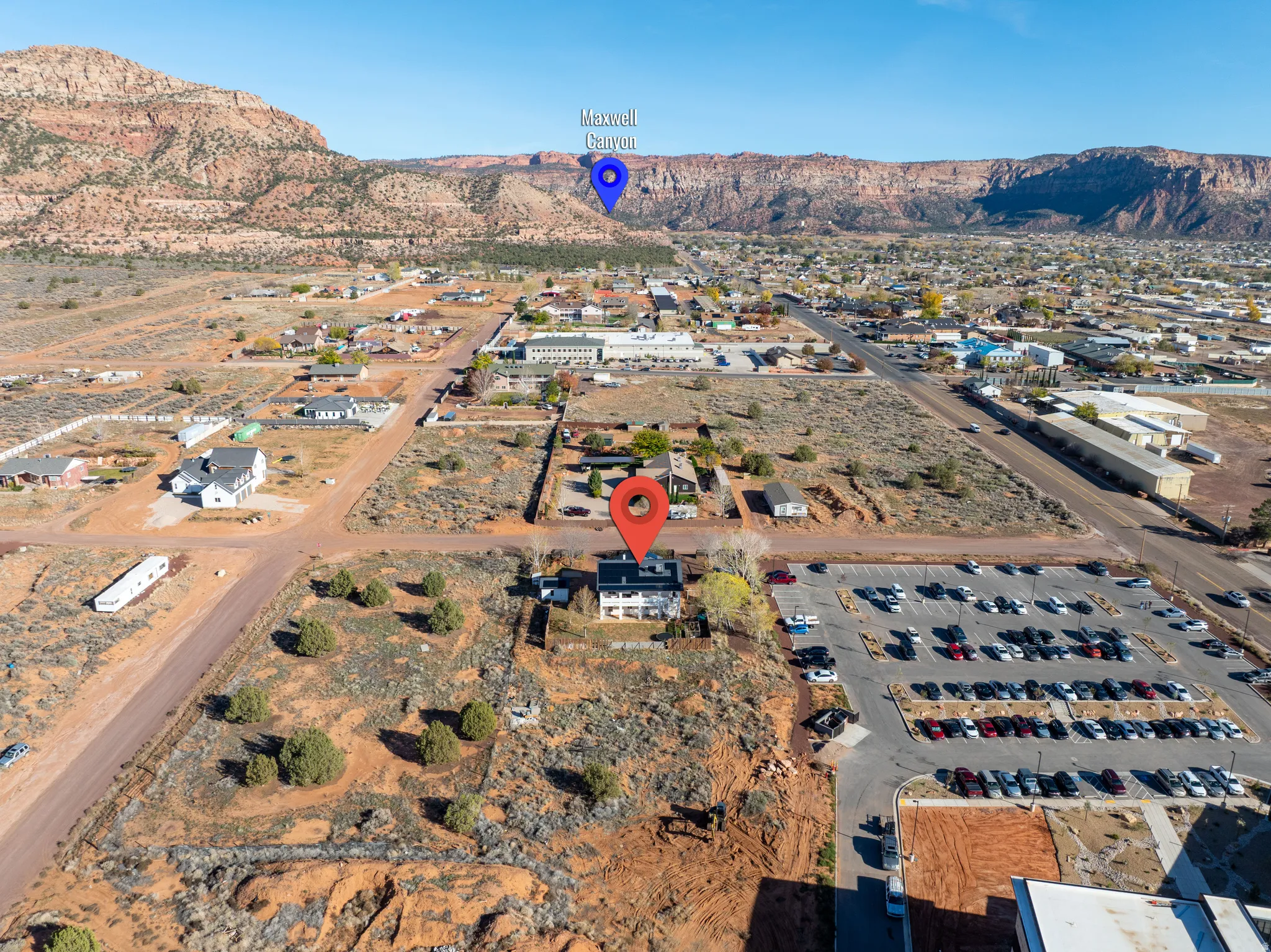 Aerial overview of property's location with mountains and nearby suburban area