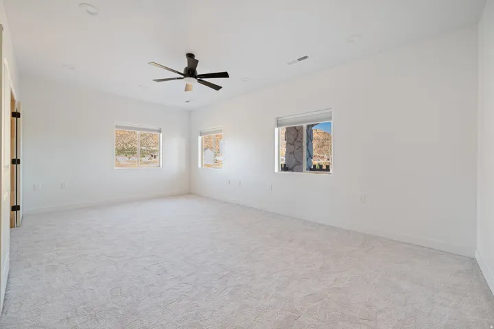 Unfurnished room featuring light carpet, a ceiling fan, and recessed lighting