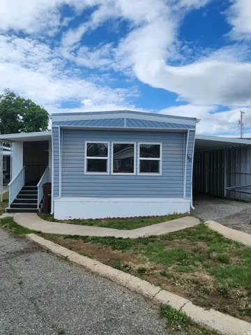 View of side of property featuring a metal roof