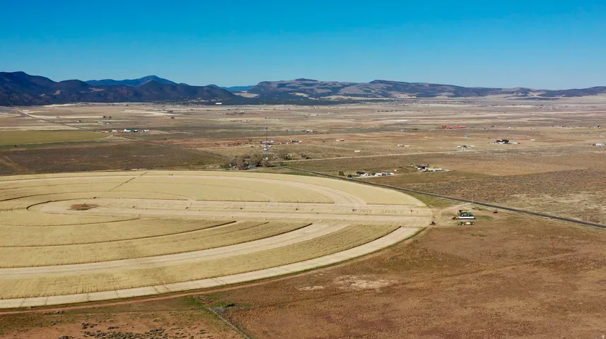 Aerial view of sparsely populated area featuring a mountainous background and a desert landscape