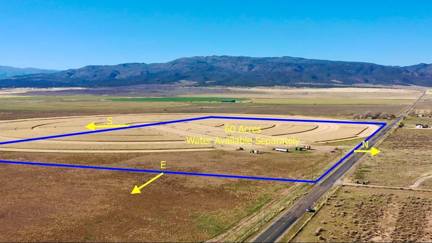Overview of rural landscape with a mountain backdrop and property parcel outlined