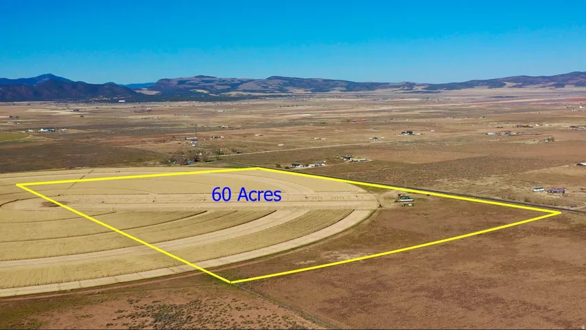 Aerial view of sparsely populated area with a mountainous background and a desert landscape