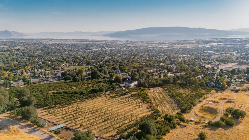 Aerial overview of property's location featuring a mountain backdrop, extensive farmland, and rural landscape