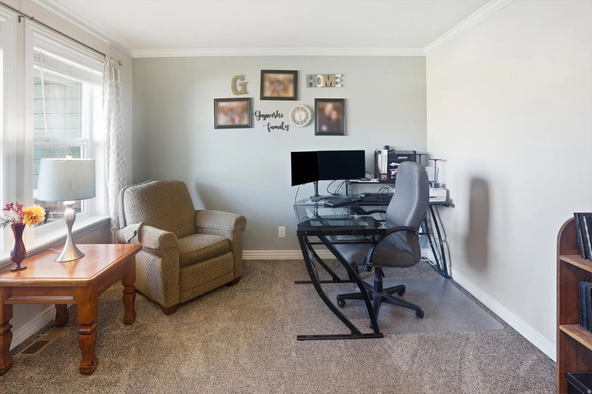 Home office featuring ornamental molding and carpet flooring