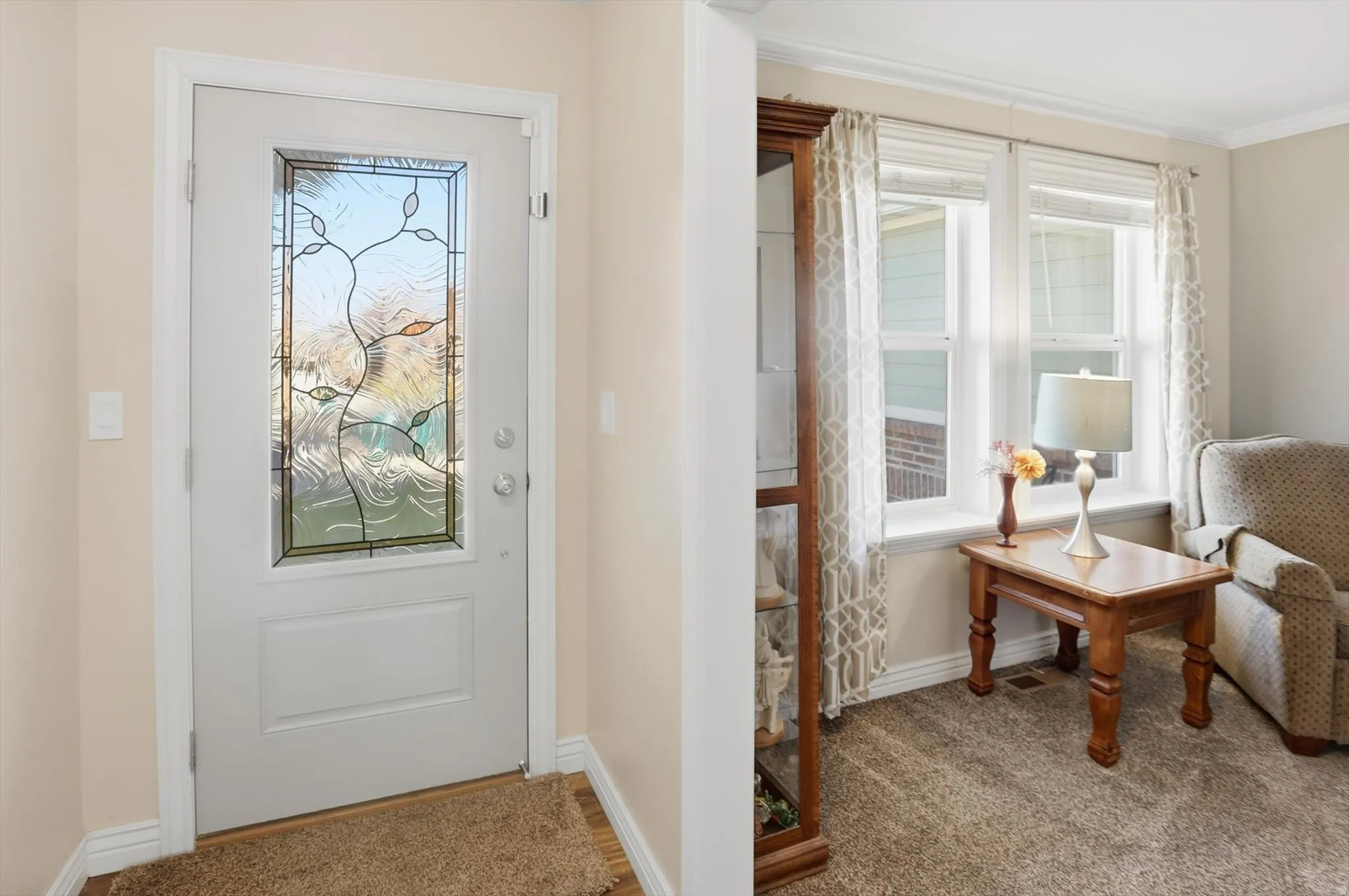 Doorway with healthy amount of natural light and carpet